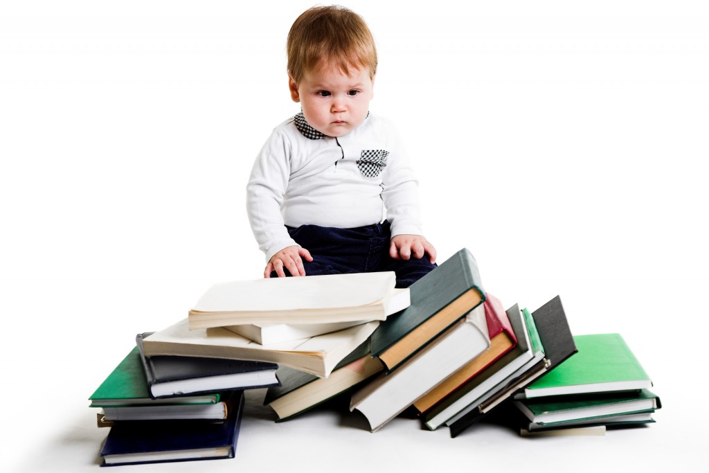 little boy with lots of books